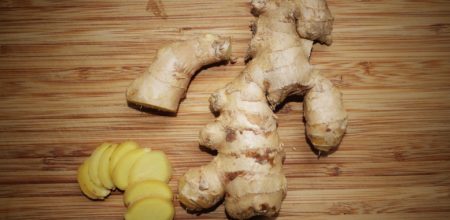 sliced up ginger on cutting board